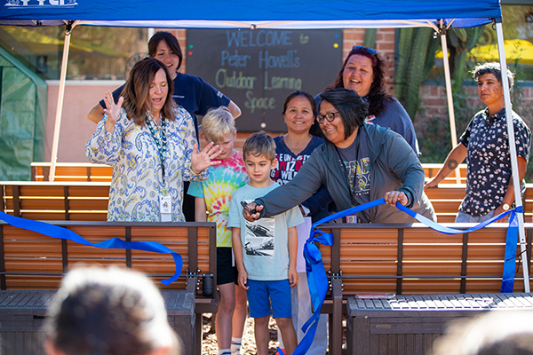 Howell students and staff help cut the blue ribbon to unveil the new outdoor learning space