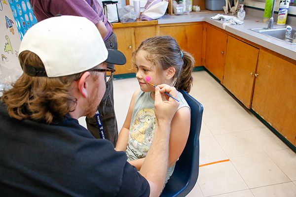 A girl has her face painted
