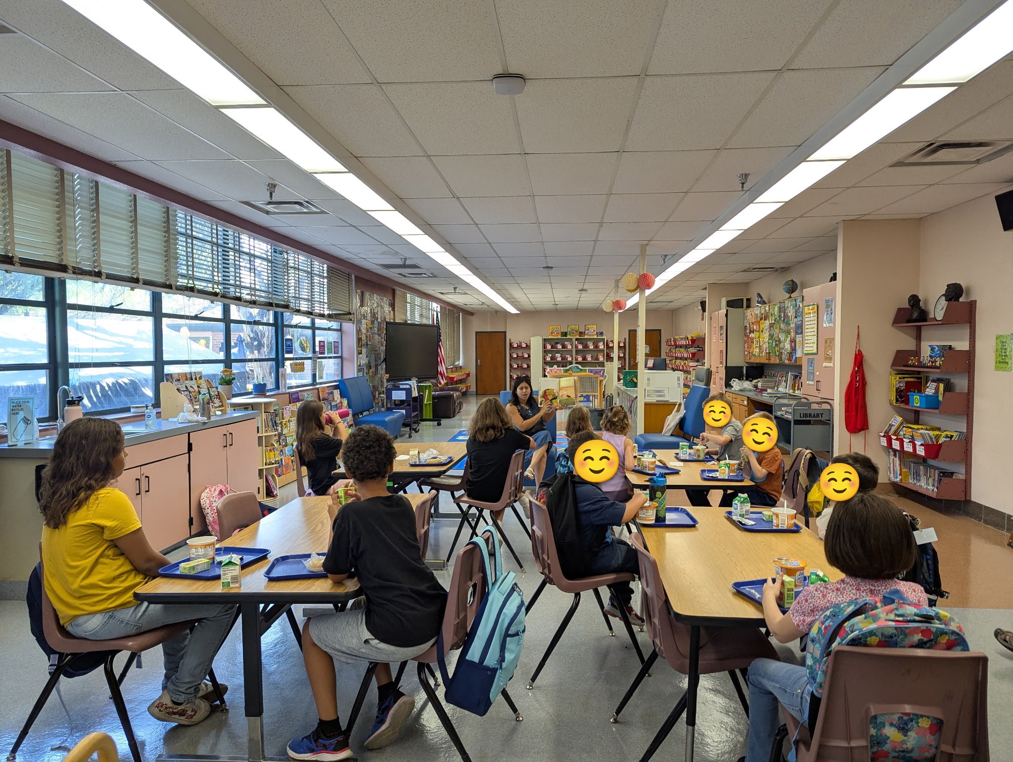Students sit in the library for story time