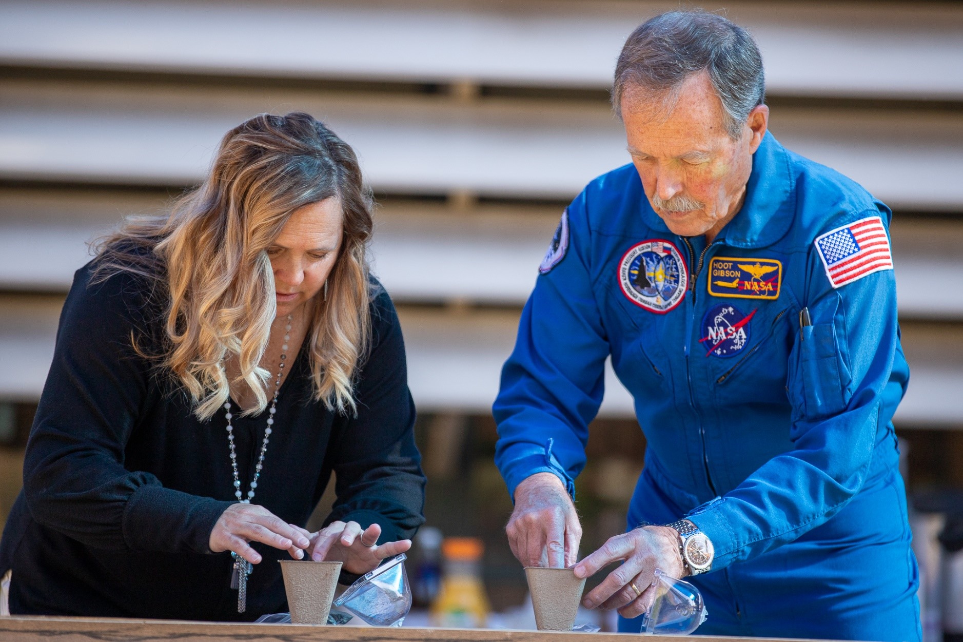 Howell's principal and former astronaut Hoot Gibson plant seeds that were sent into space